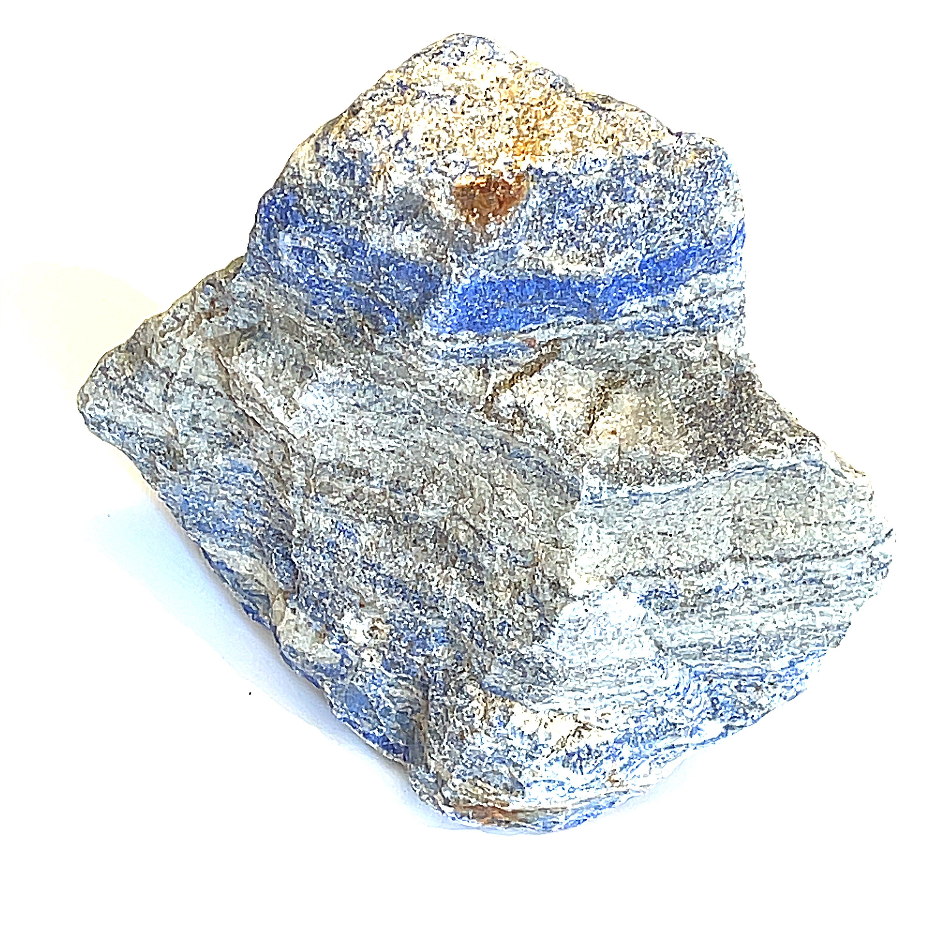 A rough, raw Lapis Lazuli gemstone with a distinctive blue color and gray matrix on a white background, front view. 