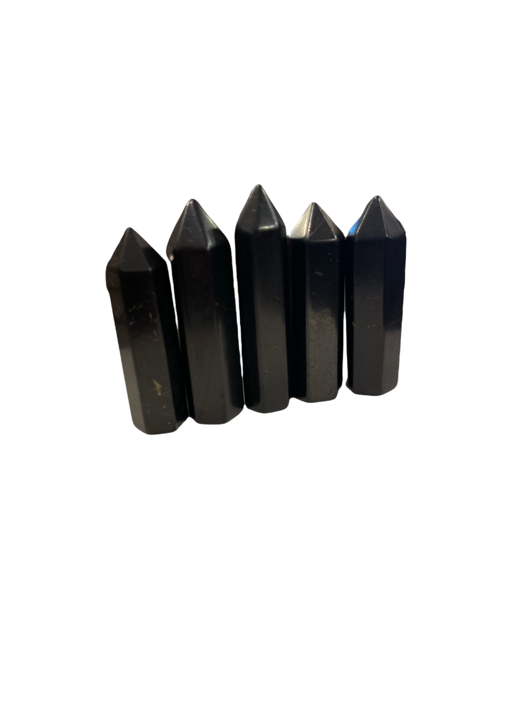 A set of five black Shungite gemstone towers of varying sizes arranged in a line on a white background, front, close up overview.