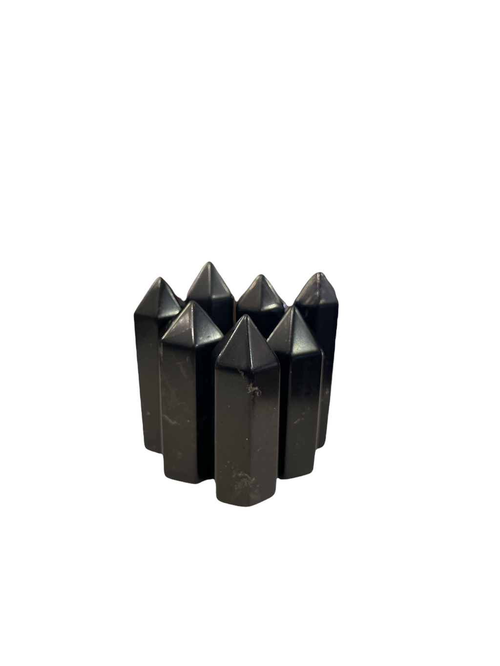 A set of seven black Shungite gemstone towers of varying sizes arranged in a triangle on a white background, front, close up overview.