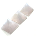 A set of three pink Mangano Calcite pyramid-shaped gemstones displayed on a white background. On a white background, center overview. 