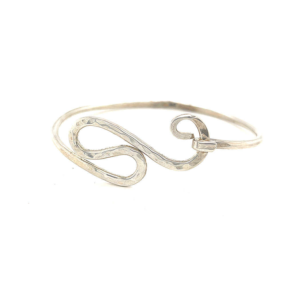 A sterling silver bangle size 7 on a white background, front overview. 