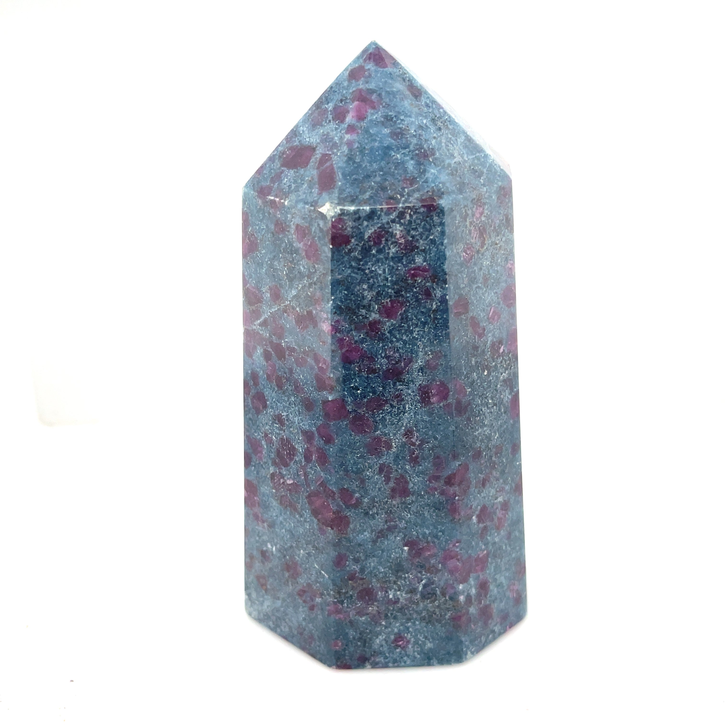A  tall  Ruby Kyanite gemstone towers with a deep blue color and red speckles, displayed on a white background, front close up overview.