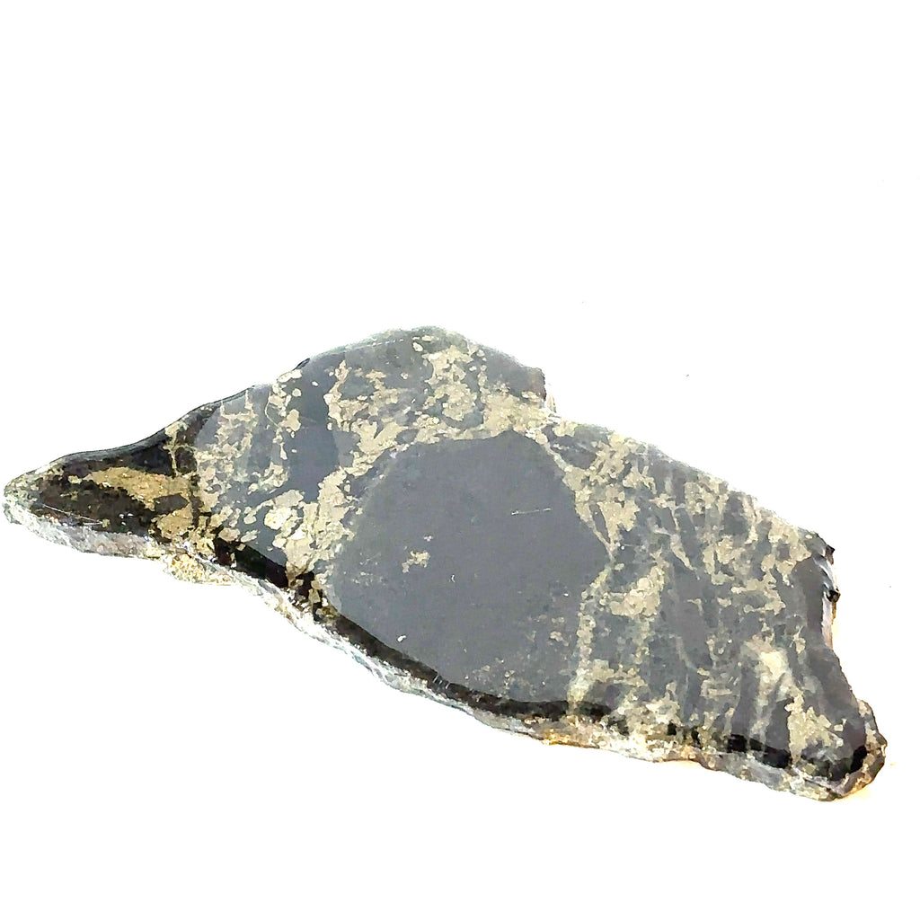 An Apache Gold gemstone laying flat on a white background, in a close-up view of the front left angle.