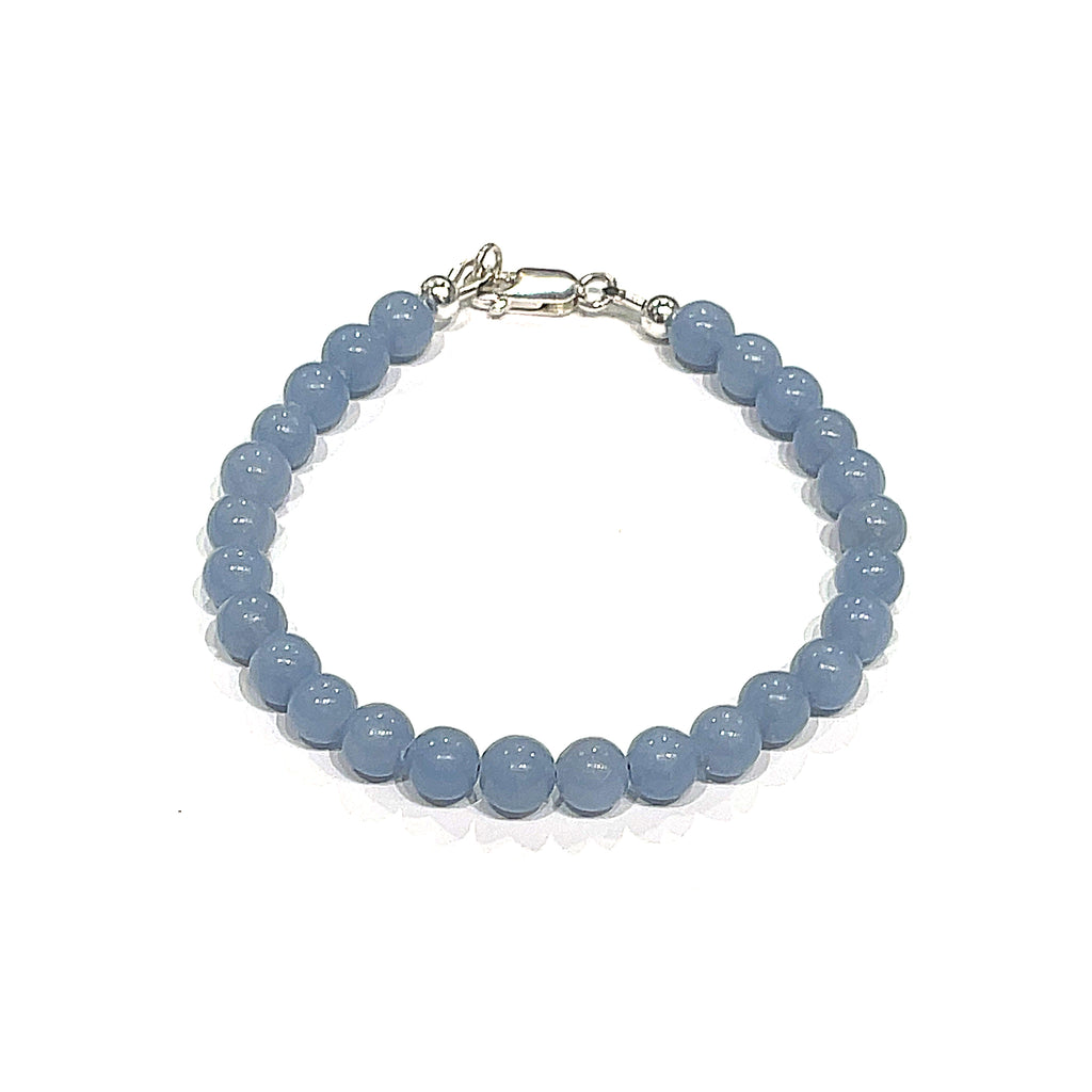 Angelite gemstone bracelet with 6mm smooth blue beads and Sterling Silver toggle clasp from Hidden Jewel of the South End on a white background front overview.