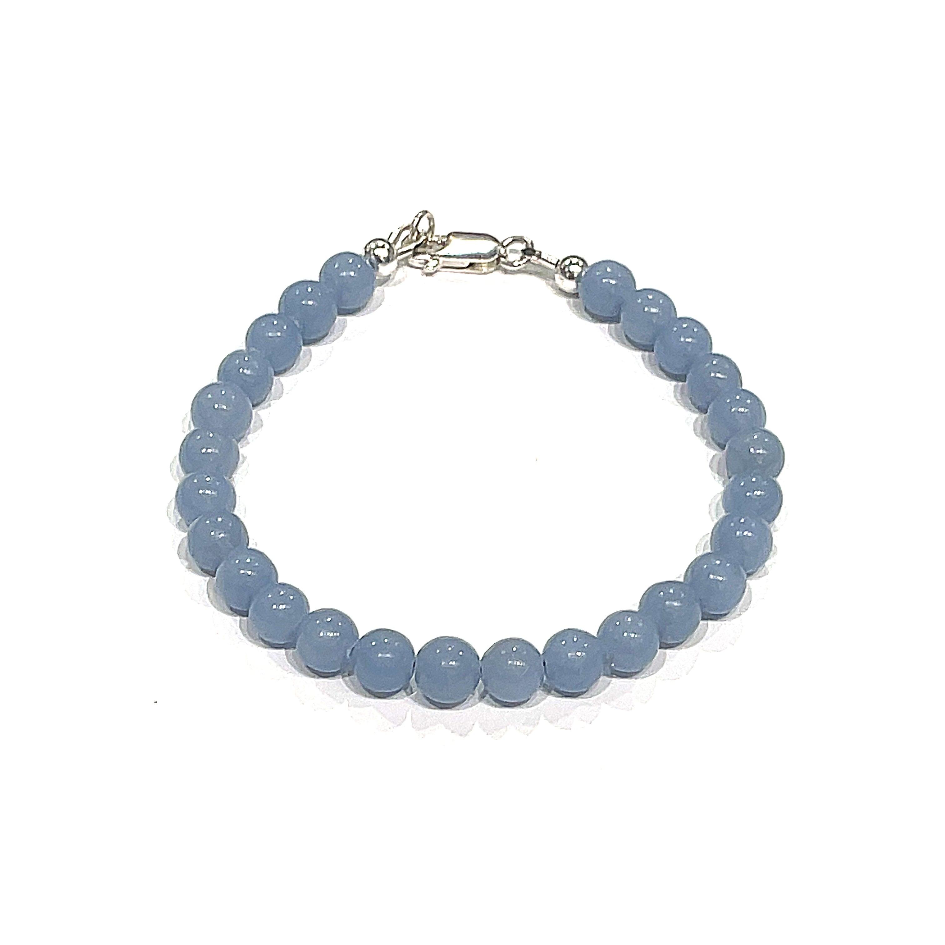 Angelite gemstone bracelet with 6mm smooth blue beads and Sterling Silver toggle clasp from Hidden Jewel of the South End on a white background front overview.