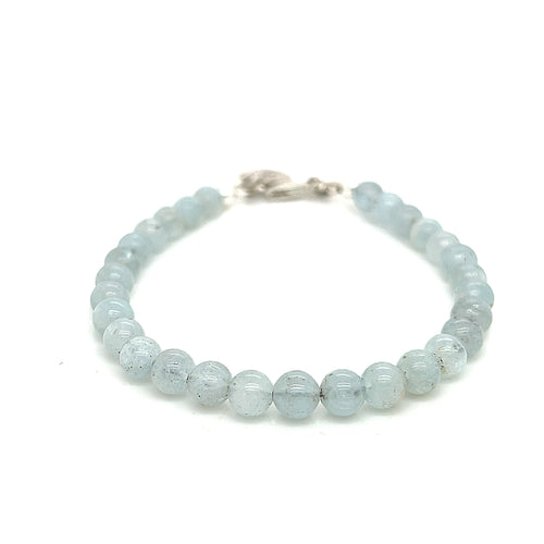 Aquamarine gemstone beaded bracelet with sterling silver lobster claw clasp showing pale blue translucent color on a white background front overview. 