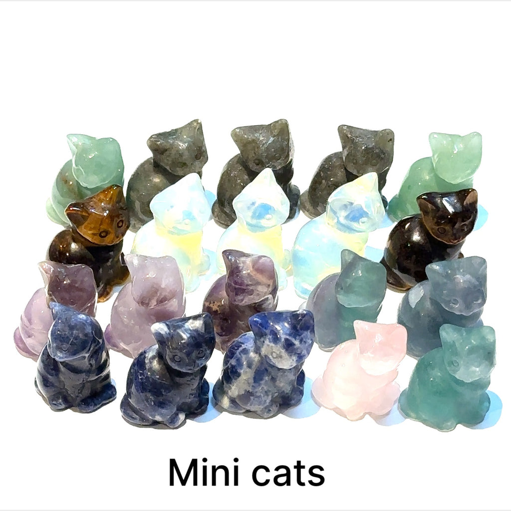 Assorted gemstone cat carvings including amethyst, jasper, and labradorite displayed on white background front overview.