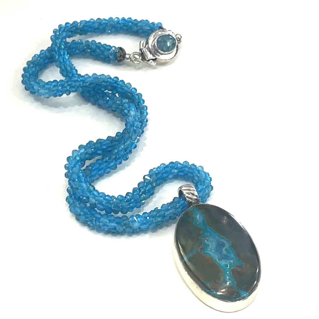 Blue Apatite crocheted gemstone necklace with Gem Silica Druzy pendant, handmade by Hidden Jewel on a white background, center overview