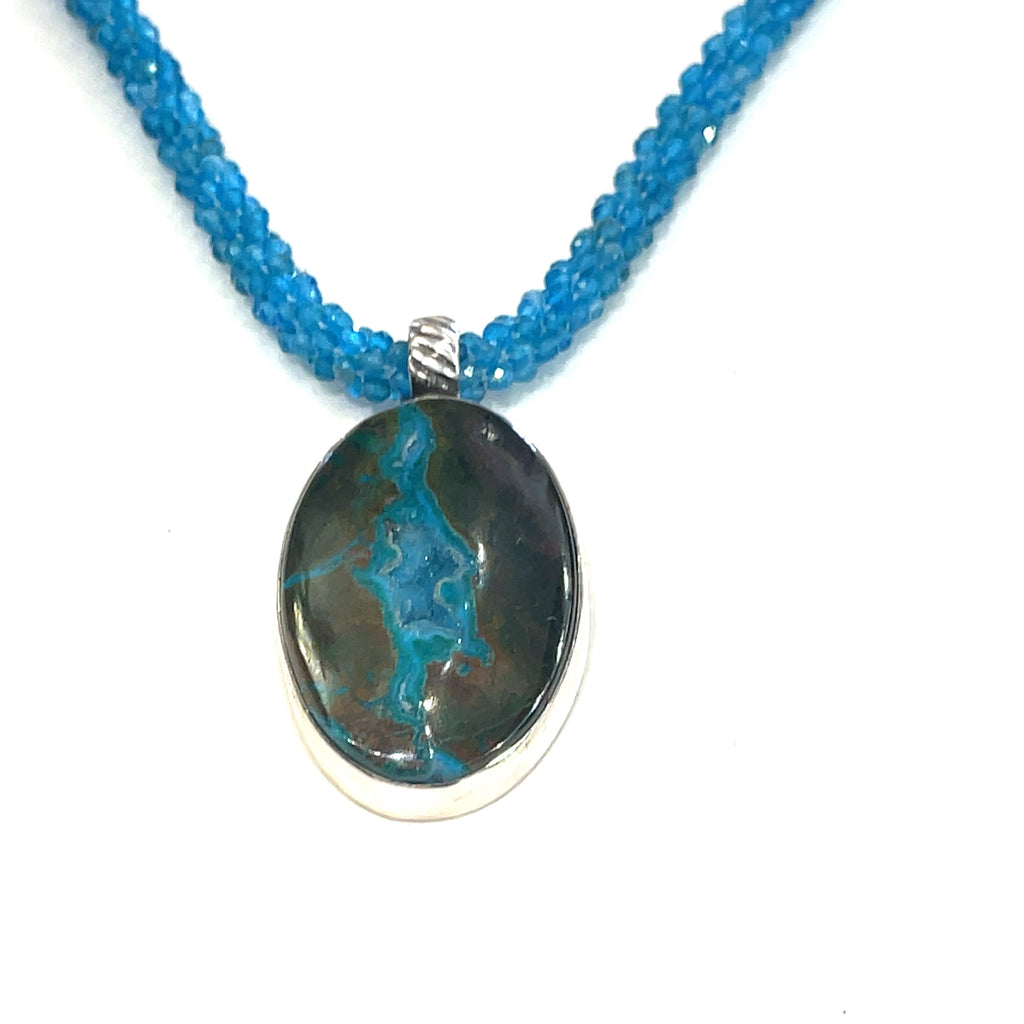 Blue Apatite crocheted gemstone necklace with Gem Silica Druzy pendant, handmade by Hidden Jewel on a white background, hanging overview