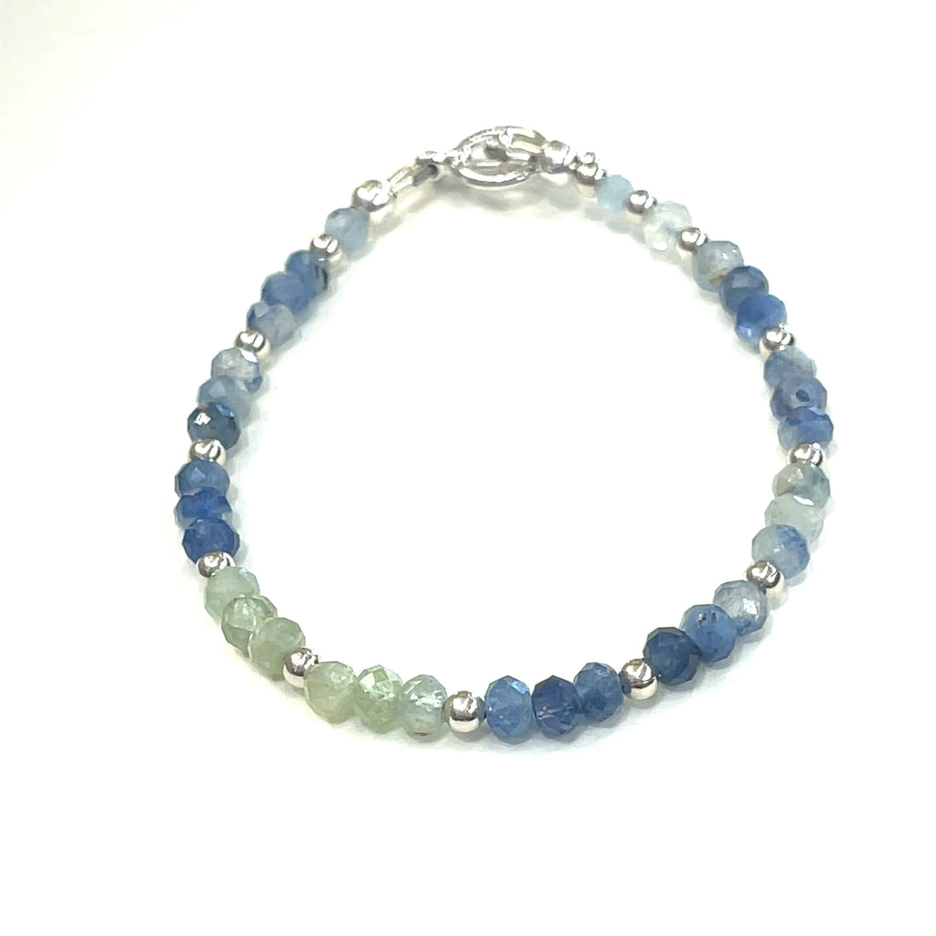 Blue and Green Kyanite faceted gemstone bracelet with sterling silver  beades and toggle on a white background front, close up overview.