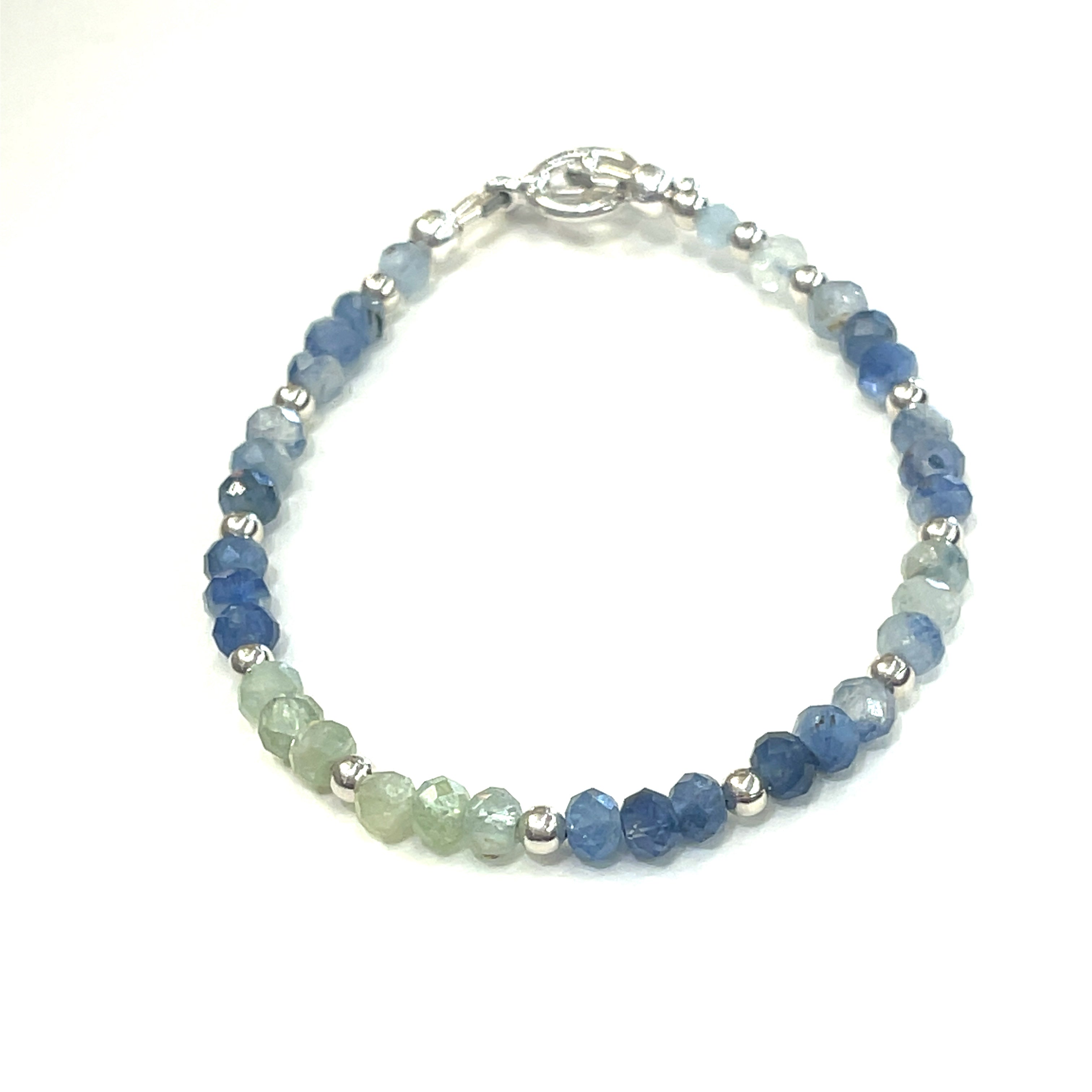 Blue and Green Kyanite faceted gemstone bracelet with sterling silver  beades and toggle on a white background front, close up overview.