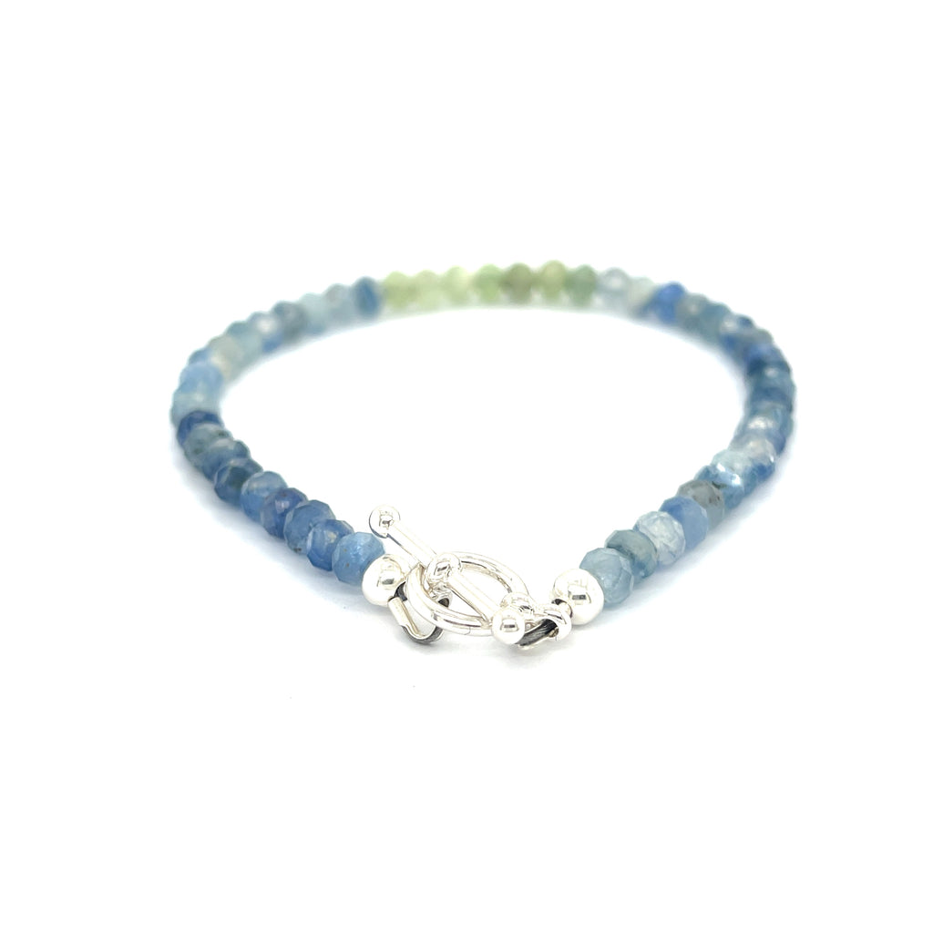Blue and Green Kyanite faceted gemstone bracelet with sterling silver toggle on a white background back and center overview.