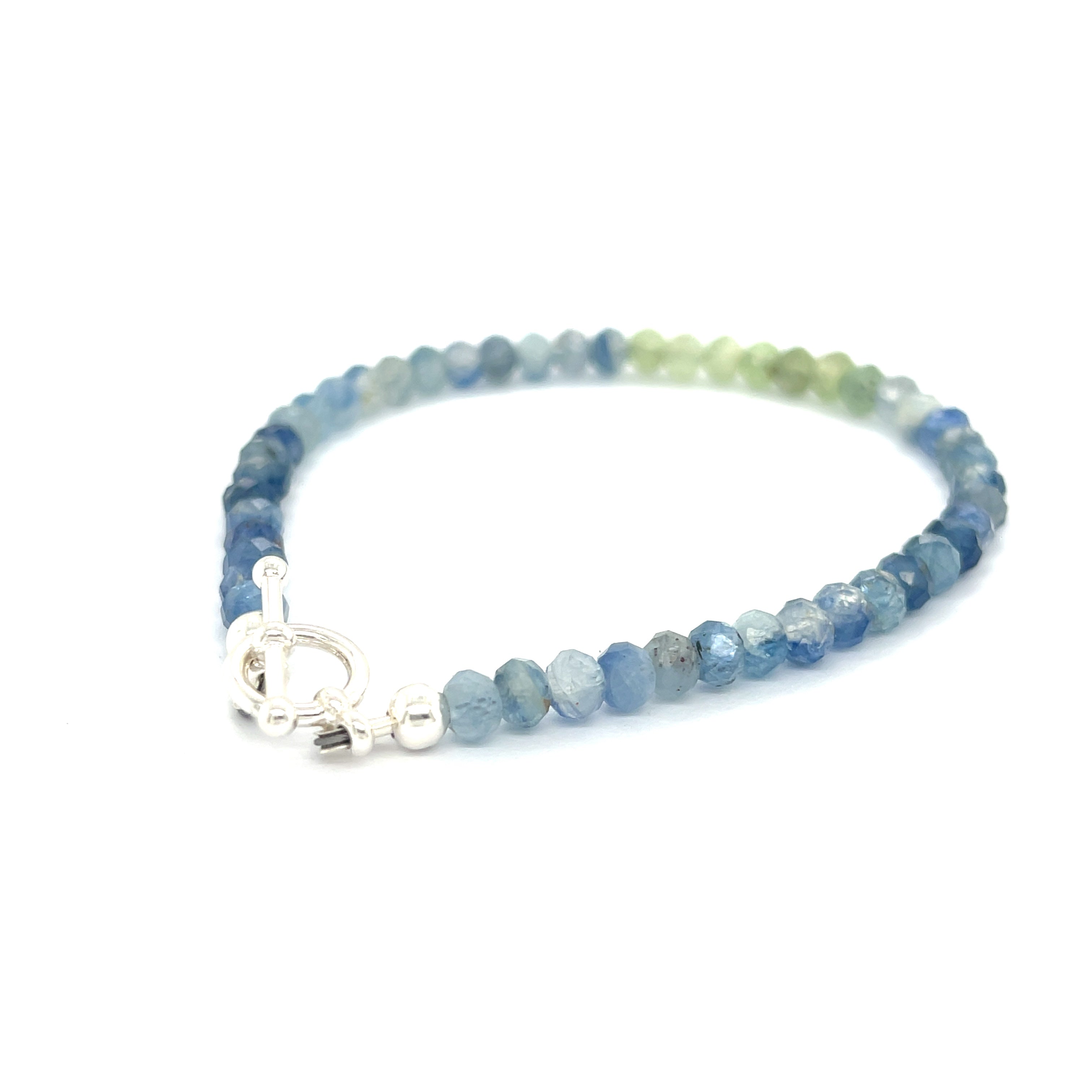 Blue and Green Kyanite faceted gemstone bracelet with sterling silver toggle on a white background back overview. 
