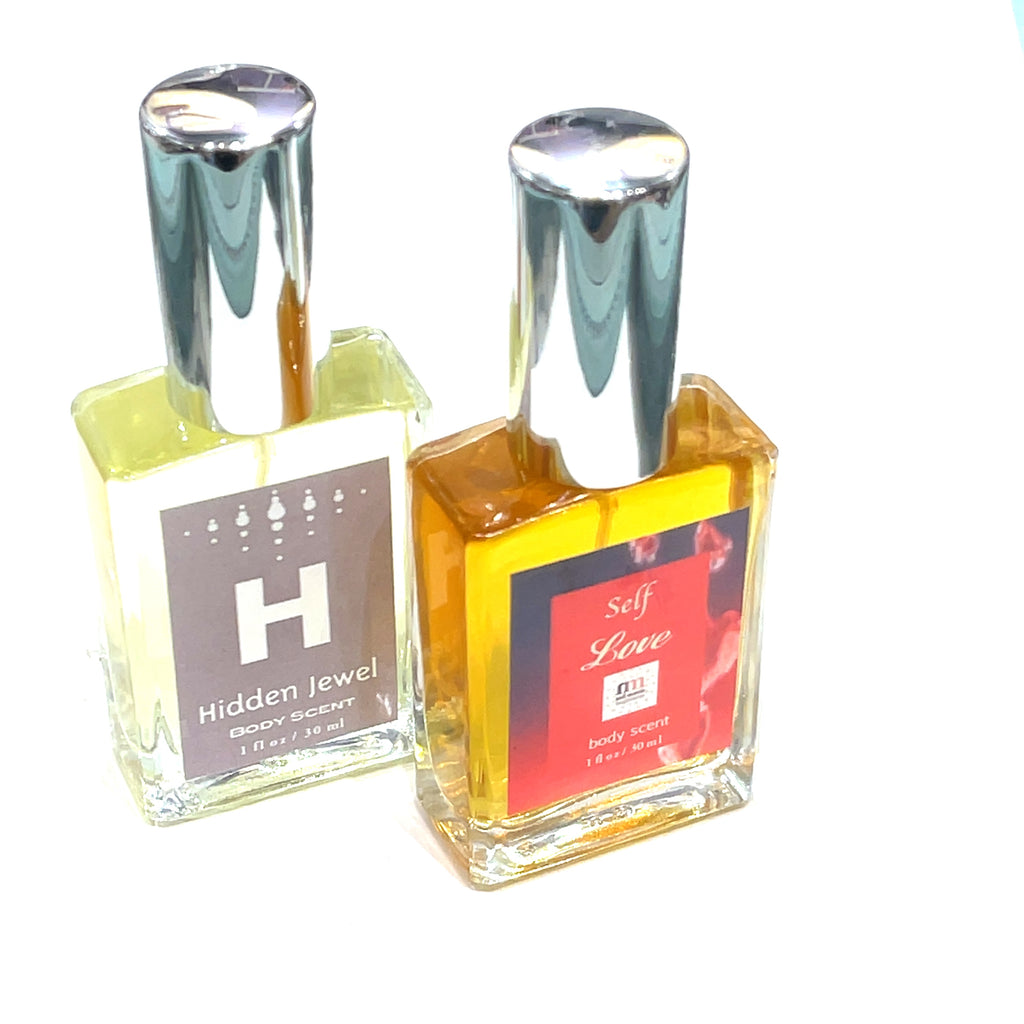  Bottle of 'Self Love: Hidden Jewel of the South End' body spray with a colorful label, and the Hidden Jewel Body Sent on a white background, and front view.