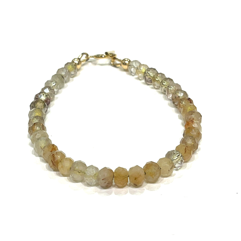 Close-up of 5mm faceted Golden Rutilated Quartz beads with visible golden inclusions on a white background, front and center overview. 