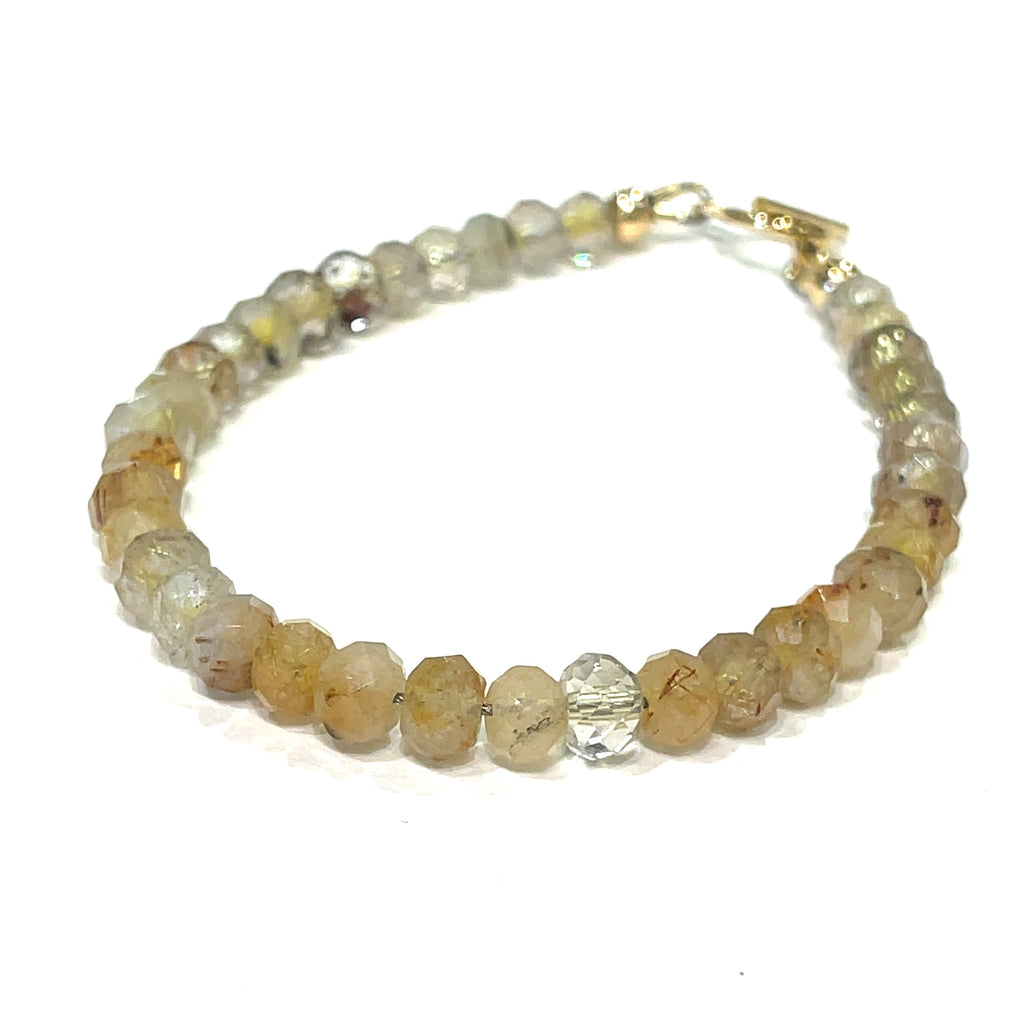 Close-up of 5mm faceted Golden Rutilated Quartz beads with visible golden inclusions on a white background, front and slight left angle overview. 