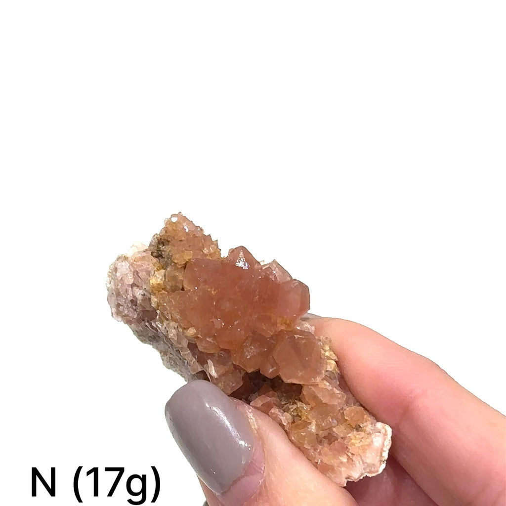 Close-up of AAA-grade Pink Amethyst cluster displaying translucent quartz and texture on white # N (17g) front view