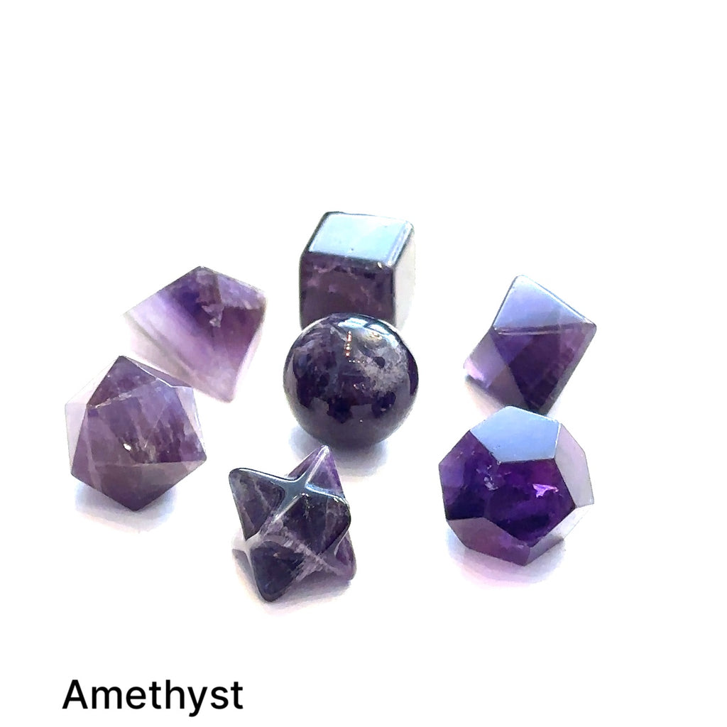 Close-up of Amethyst sacred geometry stones showing polished detail on white overview