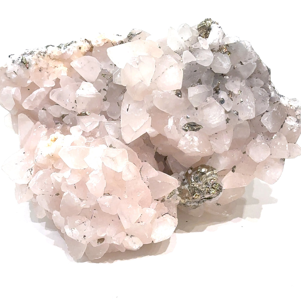 Close-up of Calcite and Fluorite crystal cluster with metallic Pyrite flecks on white background front view