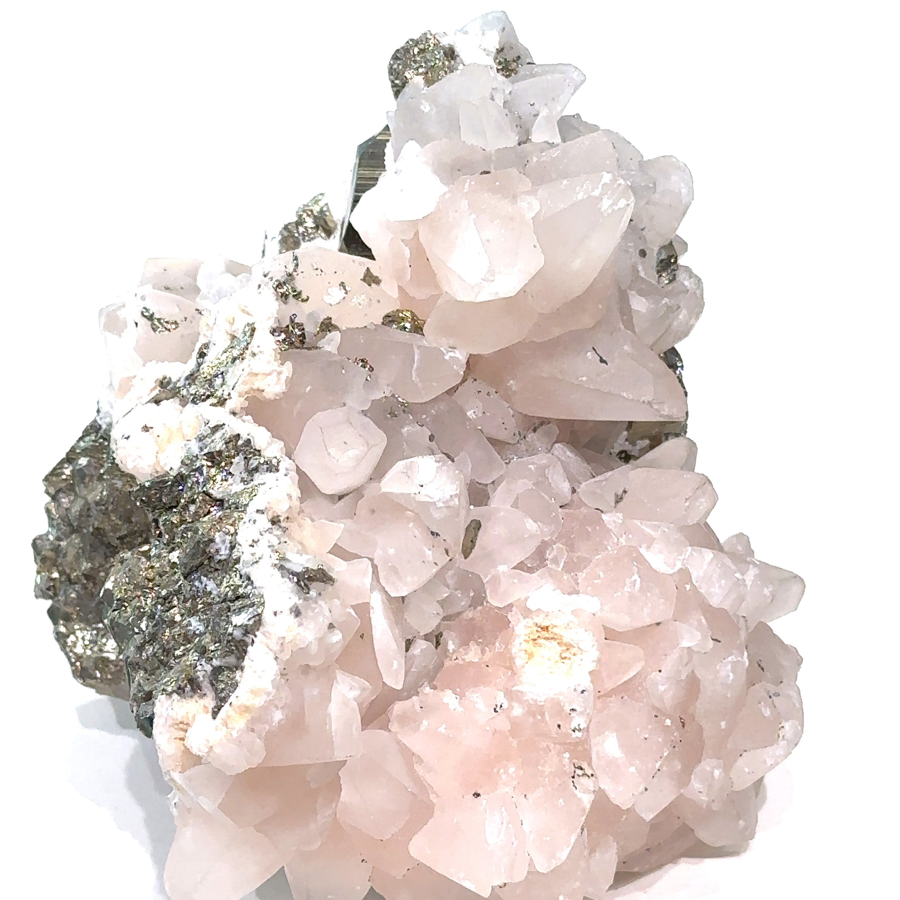 Close-up of Calcite and Fluorite crystal cluster with metallic Pyrite flecks on white background side view