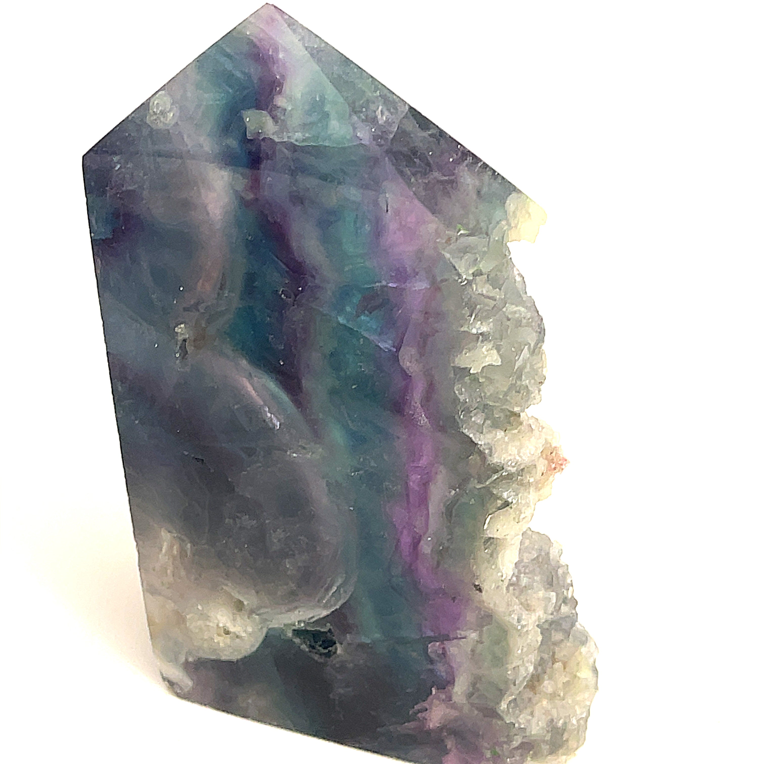 Close-up of Deep Blue and Deep purple Fluorite showing translucent layers a white background, front view. 