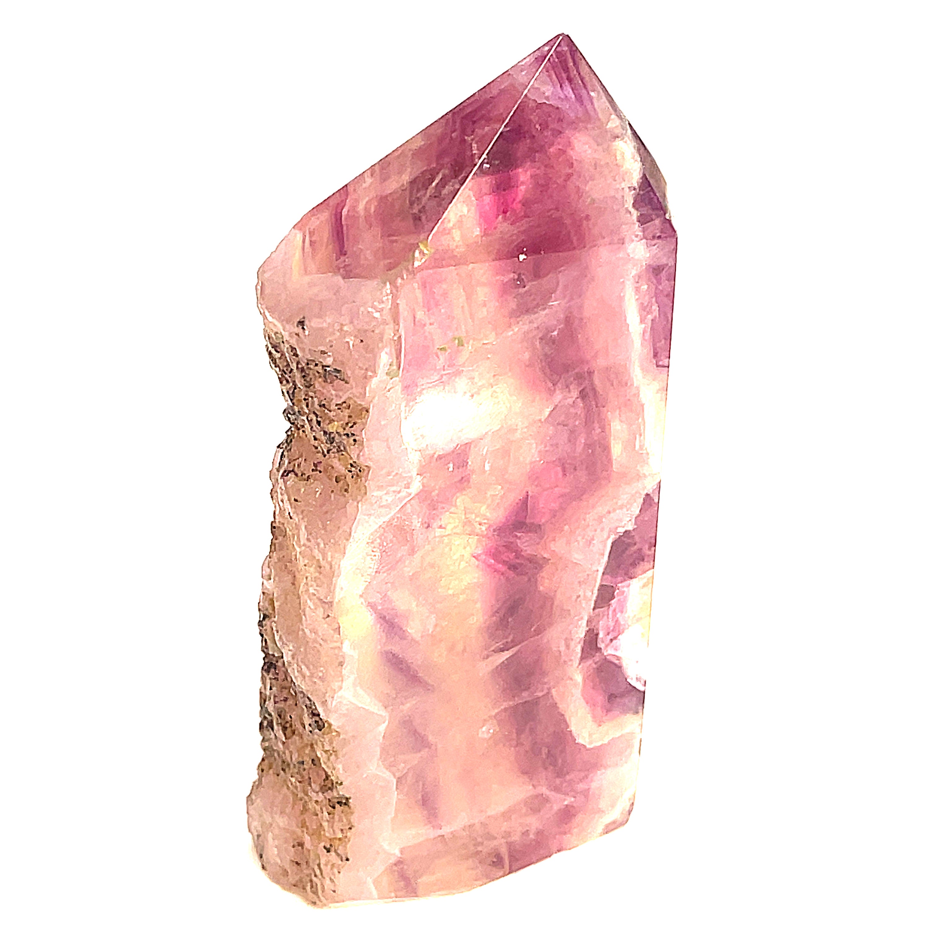 Close-up of Magenta Fluorite showing translucent layers a white background, front view. 