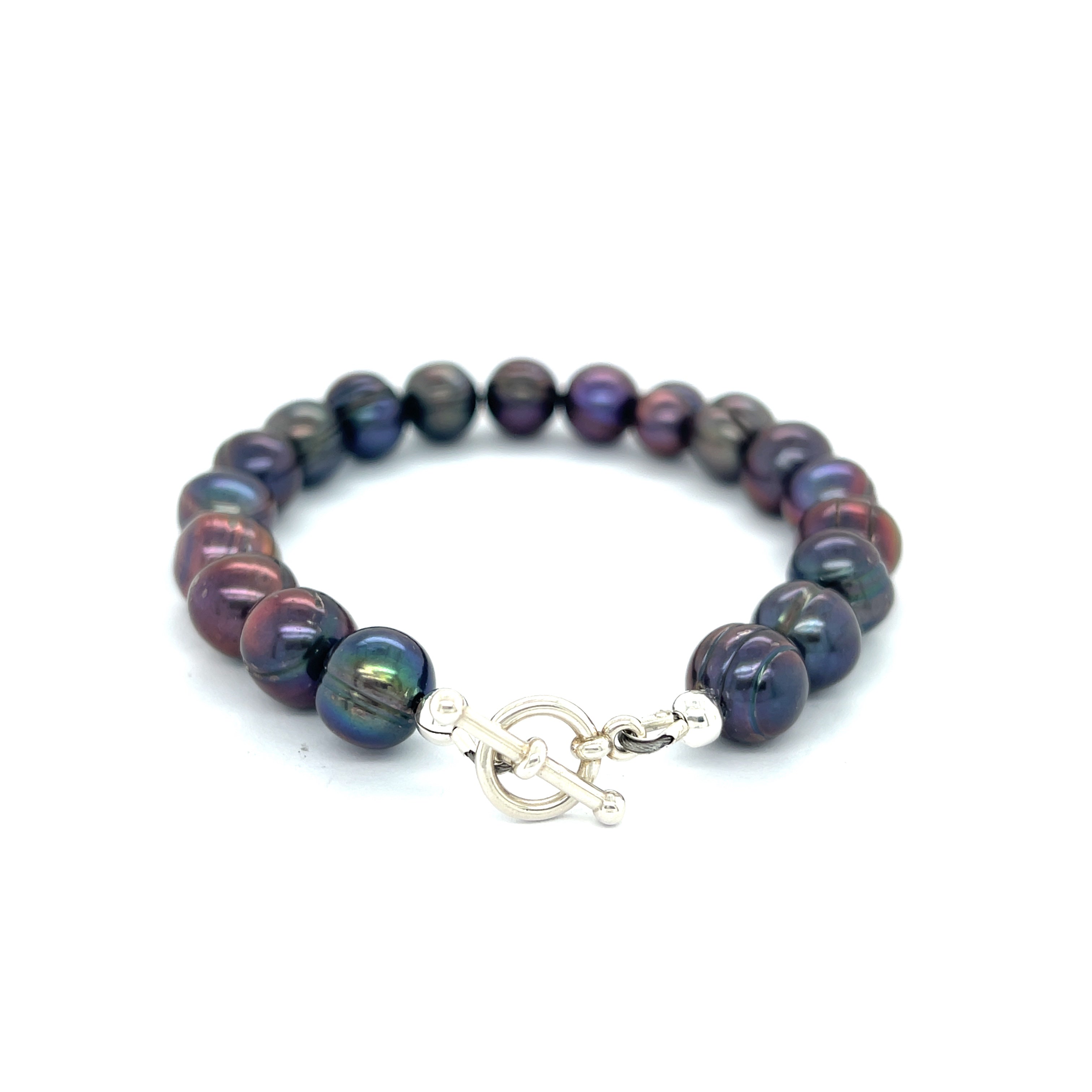 Close-up of Purple Freshwater Pearls showcasing luster and texture, handcrafted Boston jewelry on a white background back center overview.