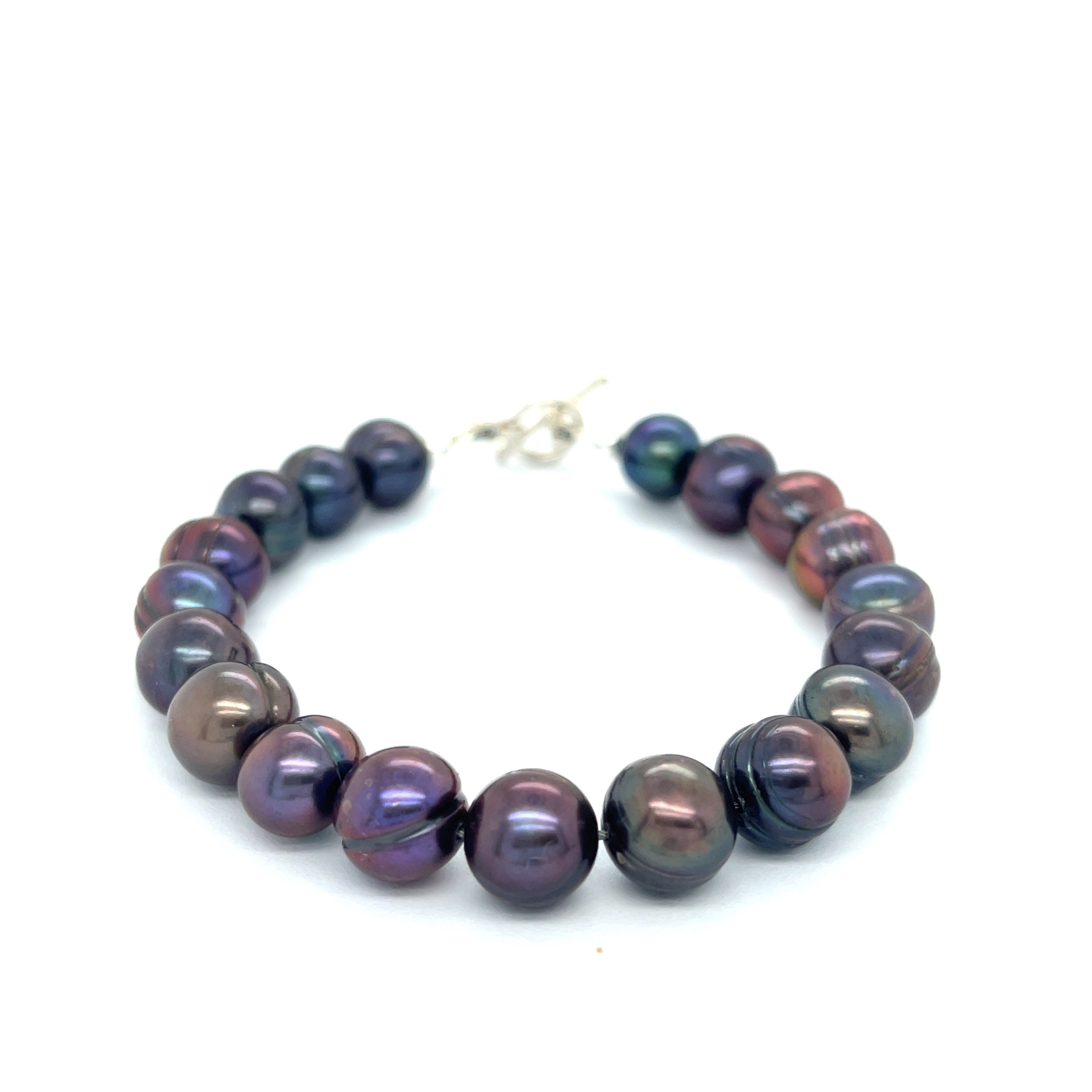 Close-up of Purple Freshwater Pearls showcasing luster and texture, handcrafted Boston jewelry on a white background front center overview.