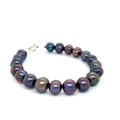 Close-up of Purple Freshwater Pearls showcasing luster and texture, handcrafted Boston jewelry on a white background front overview.