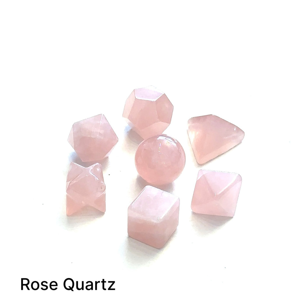 Close-up of Rose Quartz  sacred geometry stones showing polished detail on white overview