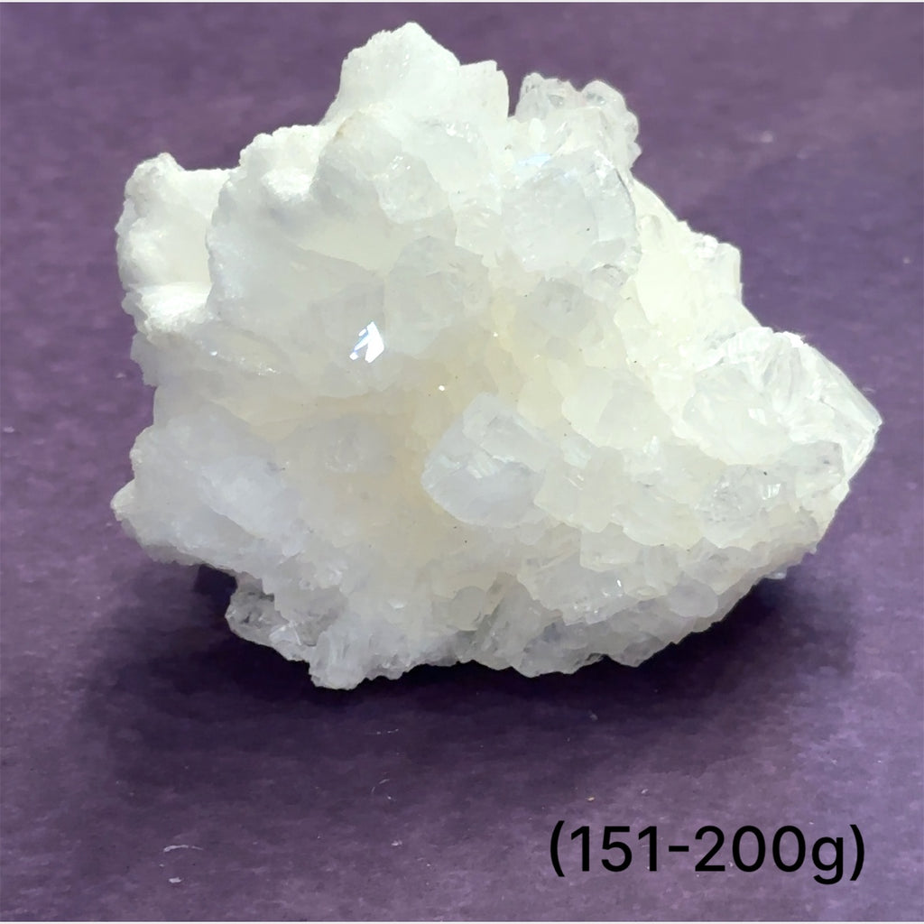 Close-up of White Aragonite cluster highlighting natural white crystal formations size (151-200g) on purple background front view.