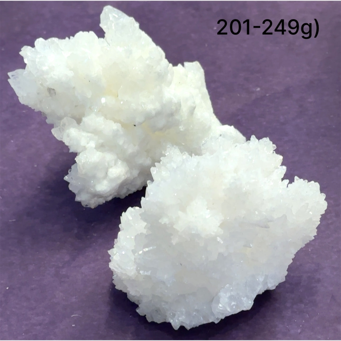 Close-up of White Aragonite cluster highlighting natural white crystal formations size (201-249g) on purple background front view.