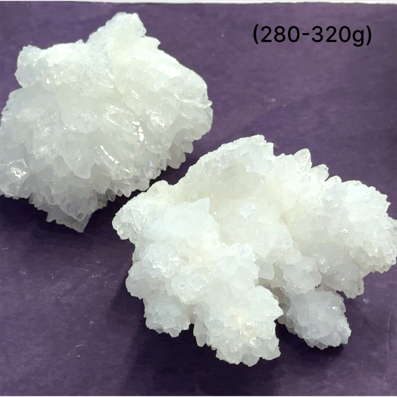 Close-up of White Aragonite cluster highlighting natural white crystal formations size (280-320g) on purple background front view.