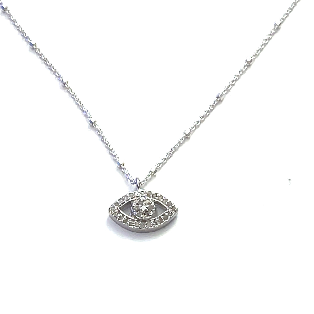 Close-up of diamond Evil Eye charm showing sparkle and silver details on a white background center hanging overview