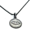 Close-up of diamond pavé Evil Eye pendant showing oxidized texture and detail on a white background long hanging overview.