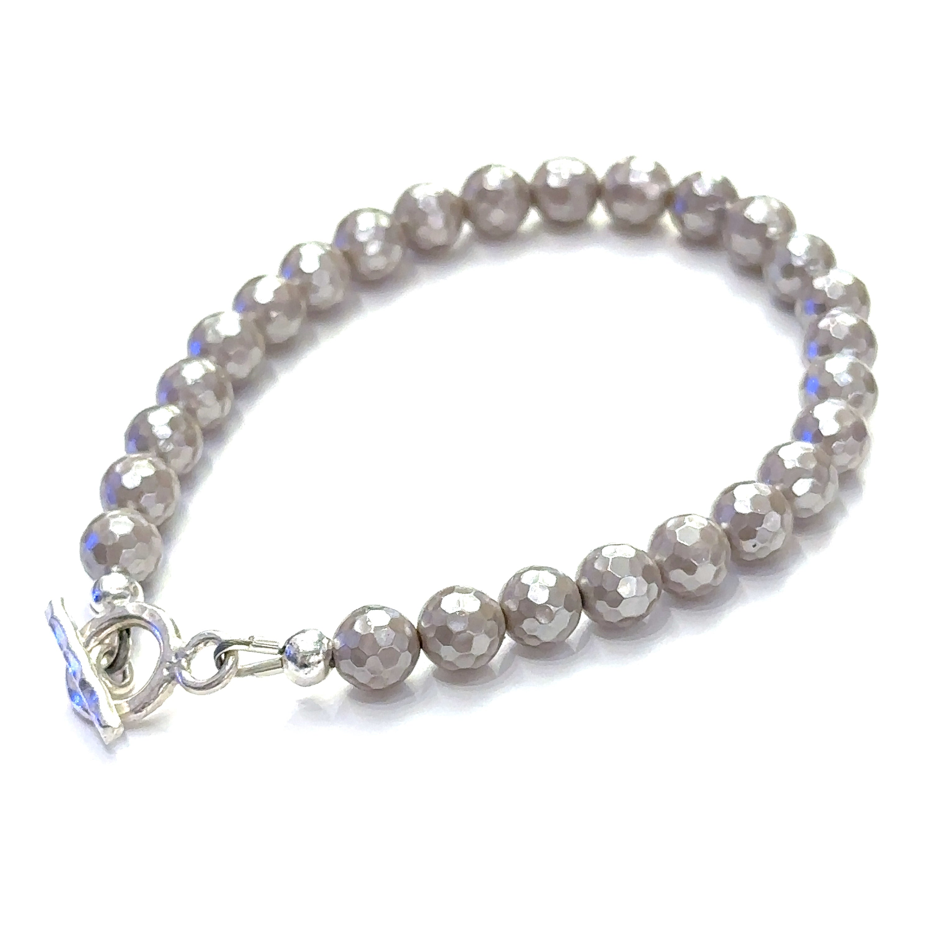 Close-up of iridescent Mother of Pearl beads showing natural shimmer and detail on a white background slight left back toggle overview.