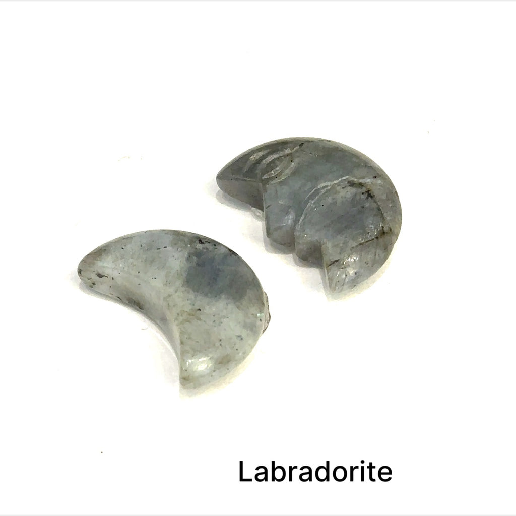 Close-up of polished moon-shaped  Labradorite gemstones grouping on a white background front overview
