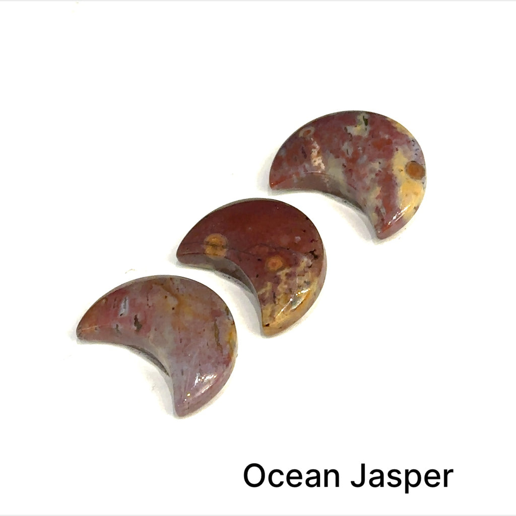 Close-up of polished moon-shaped  Ocean Jasper gemstones grouping on a white background front overview