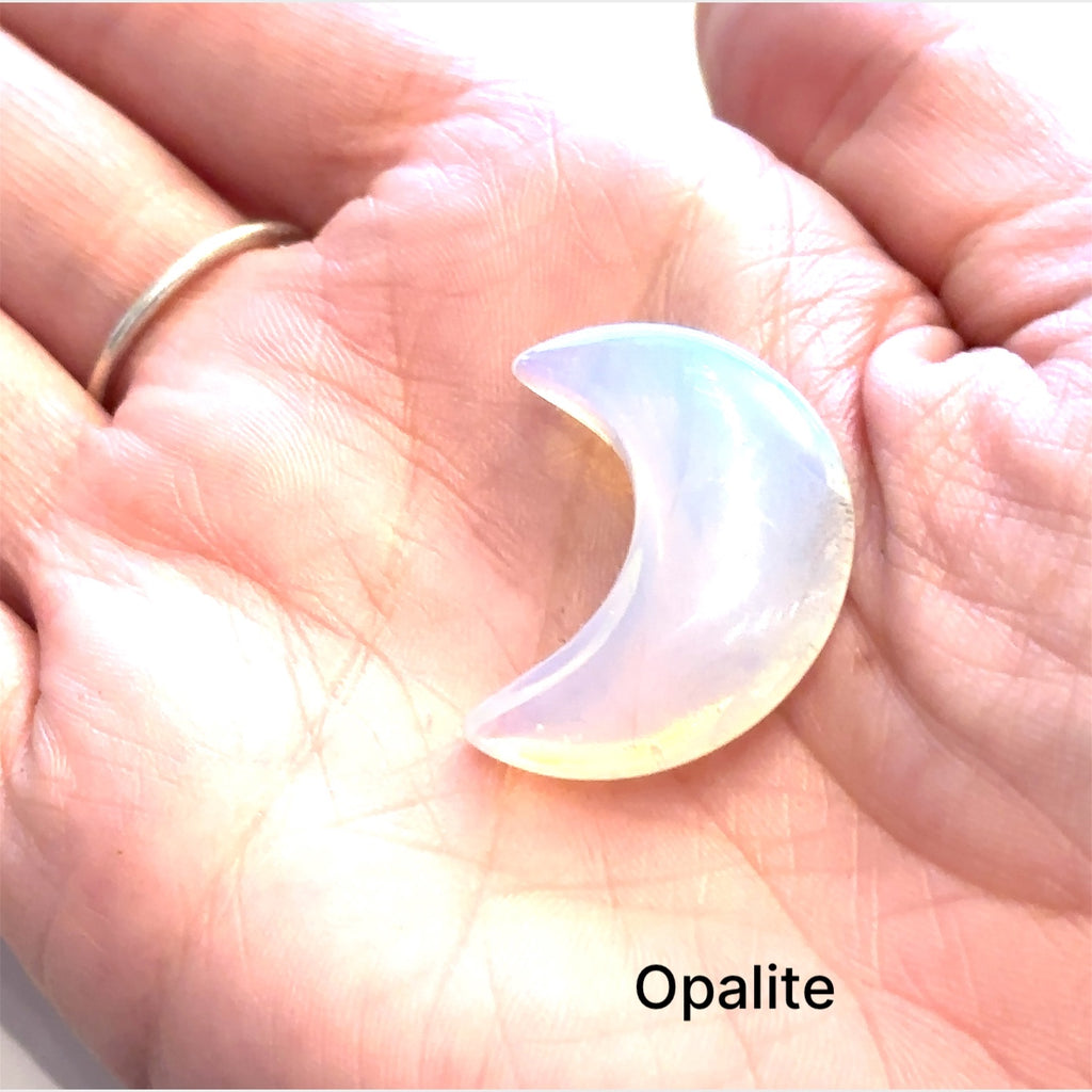 Close-up of polished moon-shaped  Opalite  gemstones grouping on a white background front overview