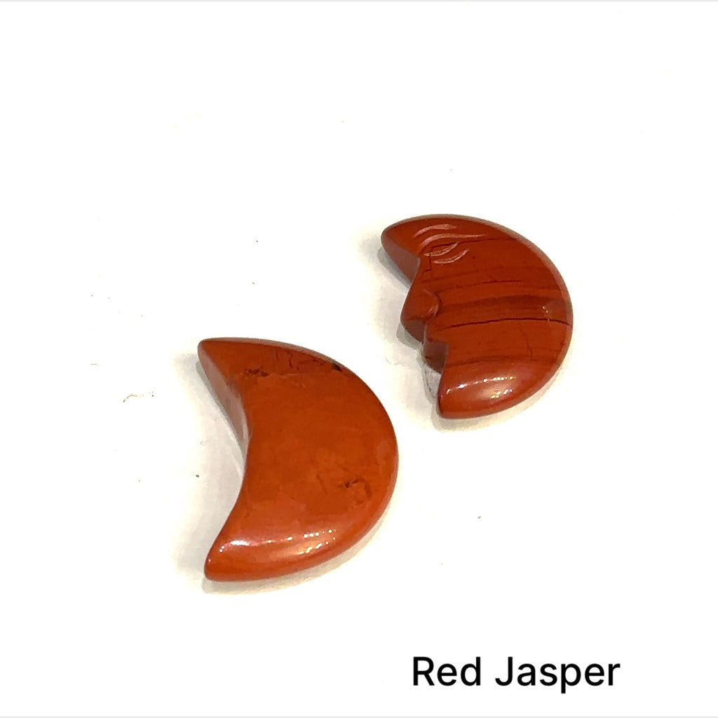Close-up of polished moon-shaped Red Jasper gemstones grouping on a white background front overview