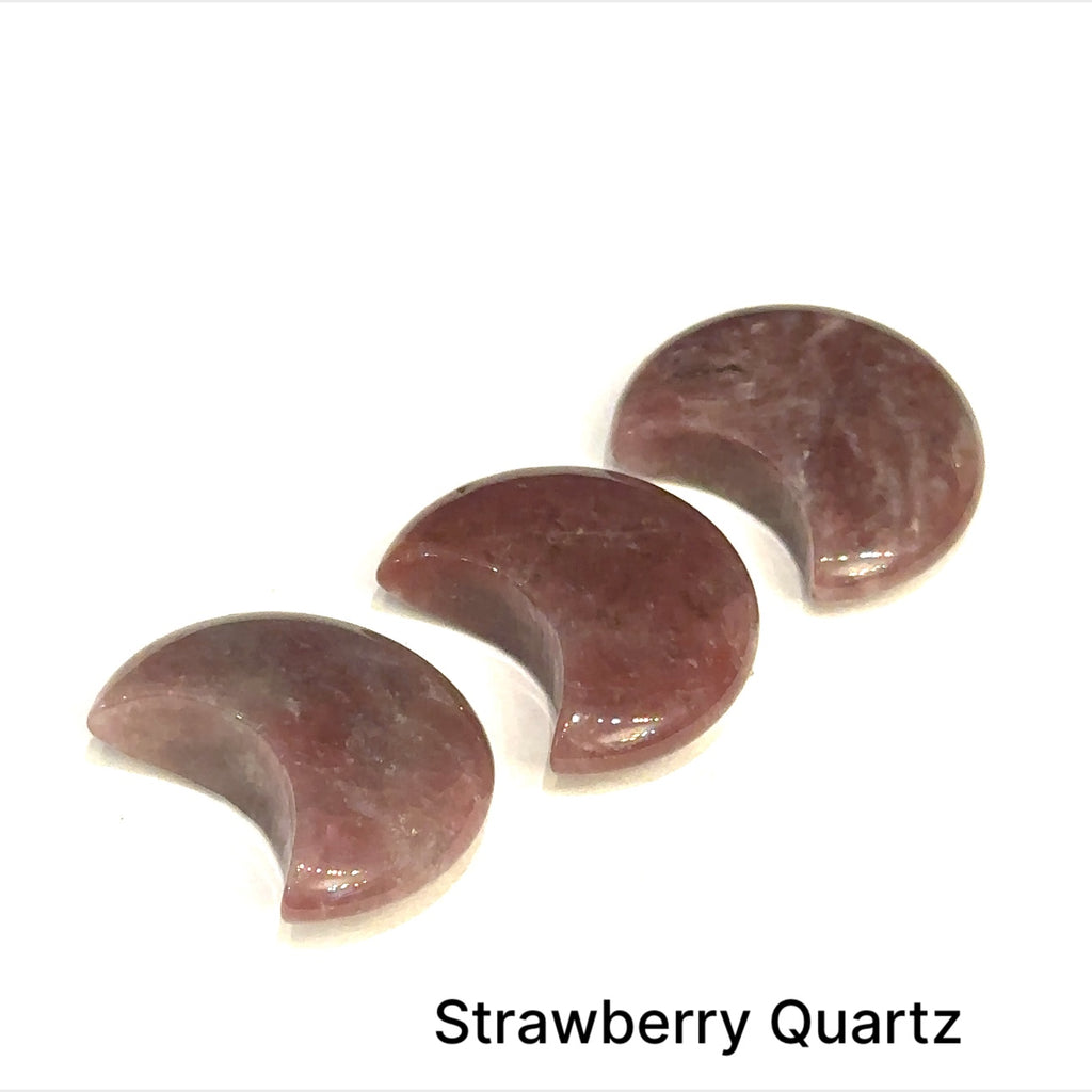 Close-up of polished moon-shaped Strawberry Quartz gemstones arranged in rows on a white background front view