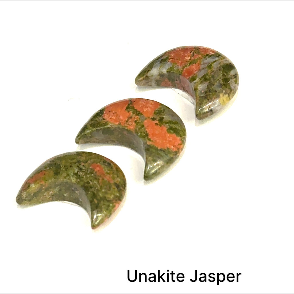 Close-up of polished moon-shaped Unakite gemstones grouping on a white background front overview