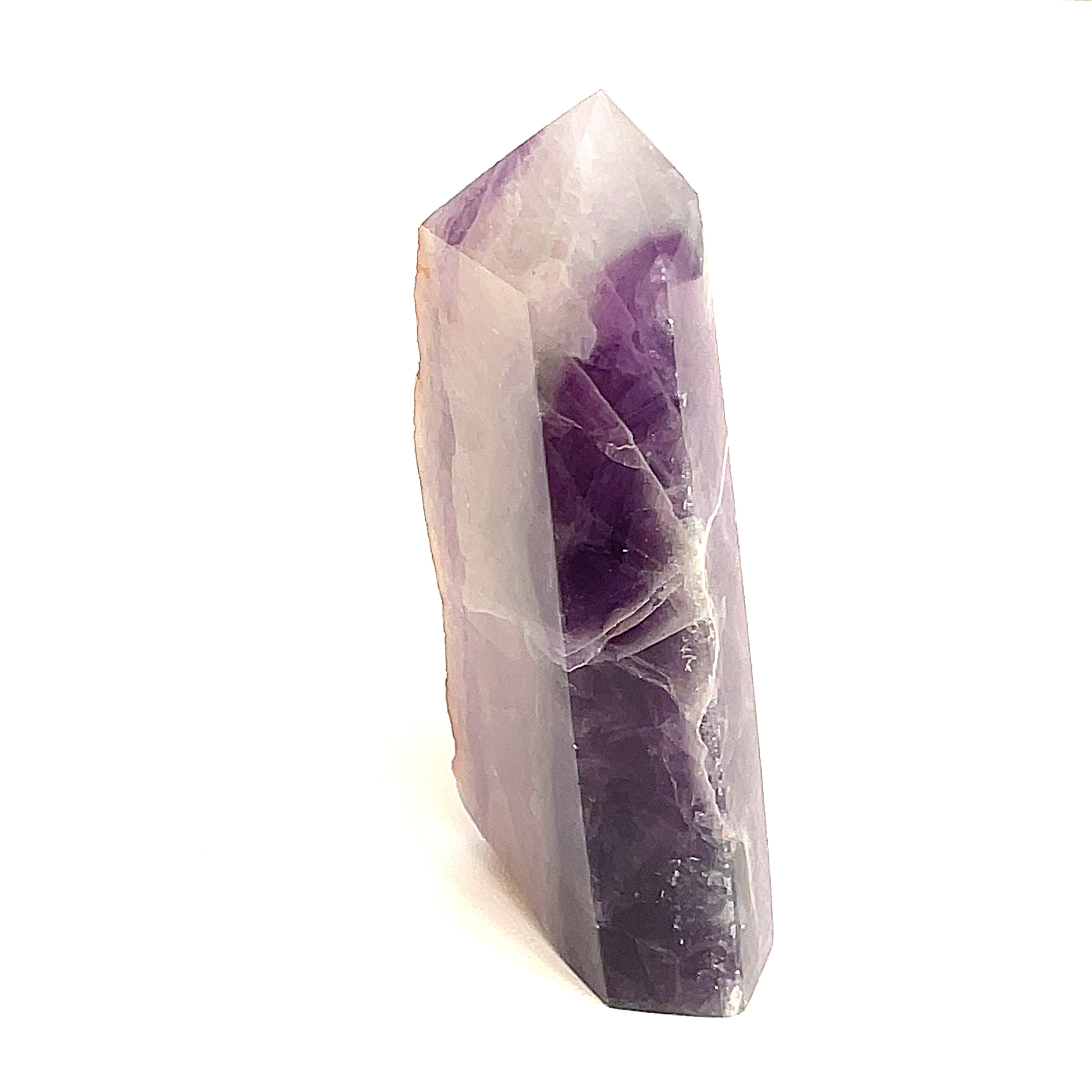 Close-up of purple Fluorite showing translucent layers a white background, front view. 