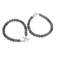 Close-up of two Iolite gemstone bracelet with 6mm beads and sterling silver toggle clasp on a white background center overview. 
