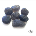 Detailed shot of authentic Colombianite obsidian “Piedra Rayo” gemstone sizes (2g) on white background overview.