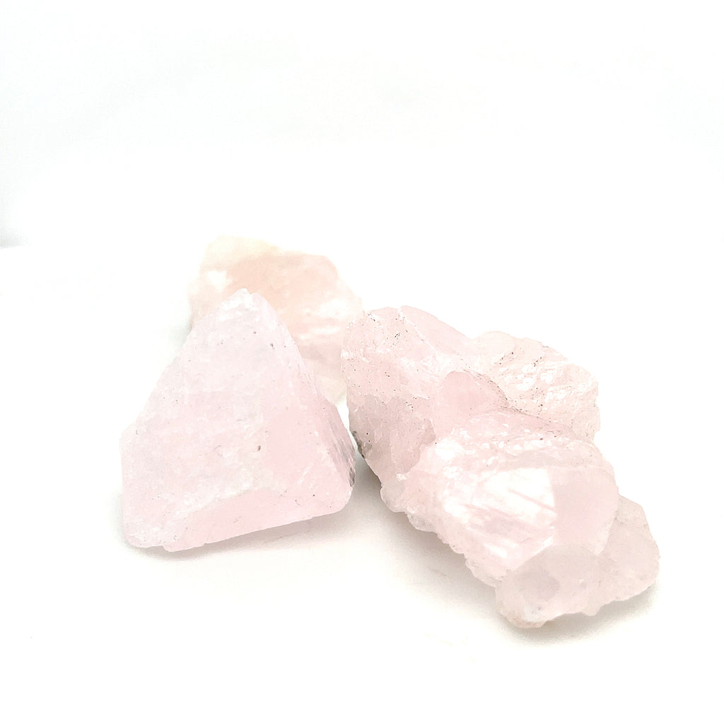 Four raw mangano calcite  on a white background, front view. 
