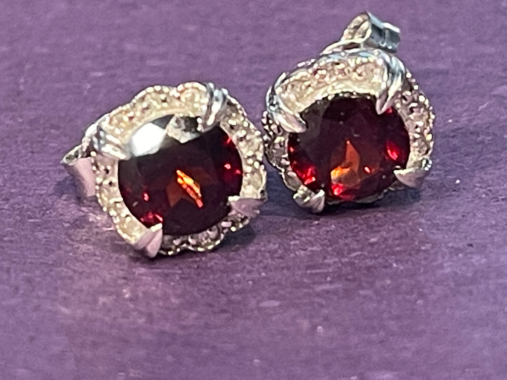Garnet Diamond Stud Earrings on a dark purple front background