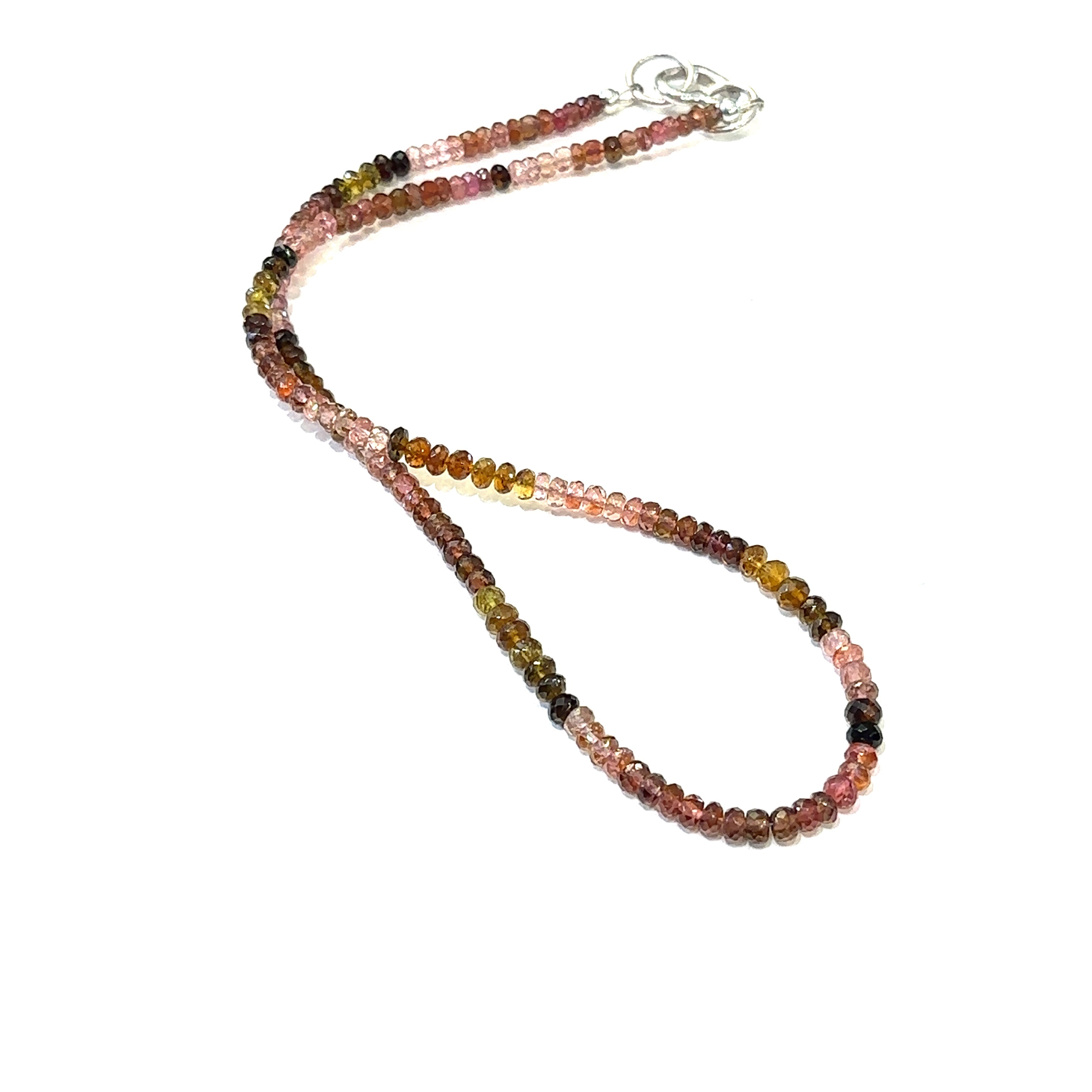 Genuine Multi Tourmaline gemstone necklace with sterling silver heart clasp by Hidden Jewel on a white background long overview.