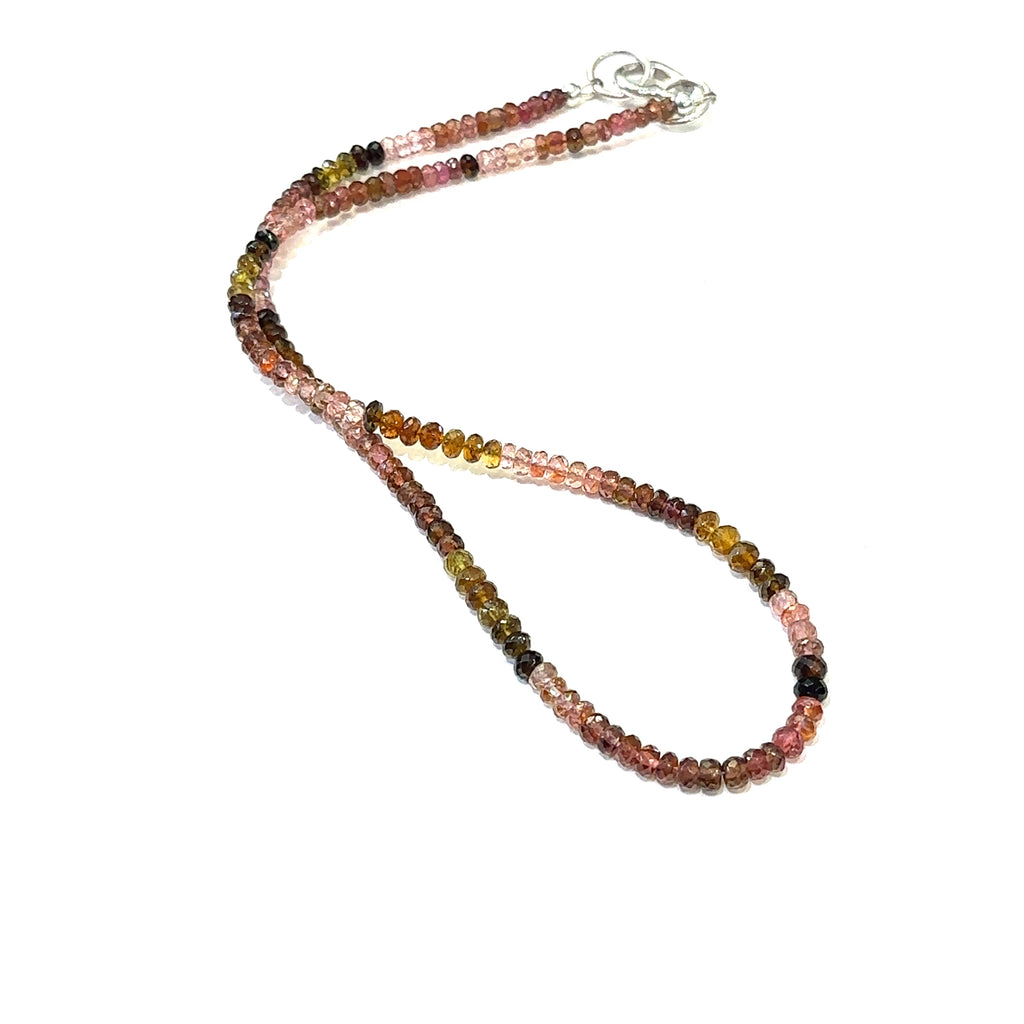 Genuine Multi Tourmaline gemstone necklace with sterling silver heart clasp by Hidden Jewel on a white background long overview.