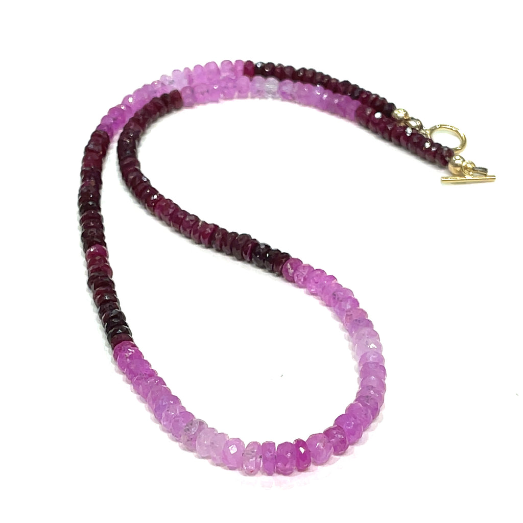 Genuine Ruby gemstone necklace with gold-filled toggle clasp by Hidden Jewel on a white background front, center long overview.